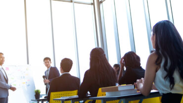 A Group Of Corporate Employees Getting Training From The Company Lead.